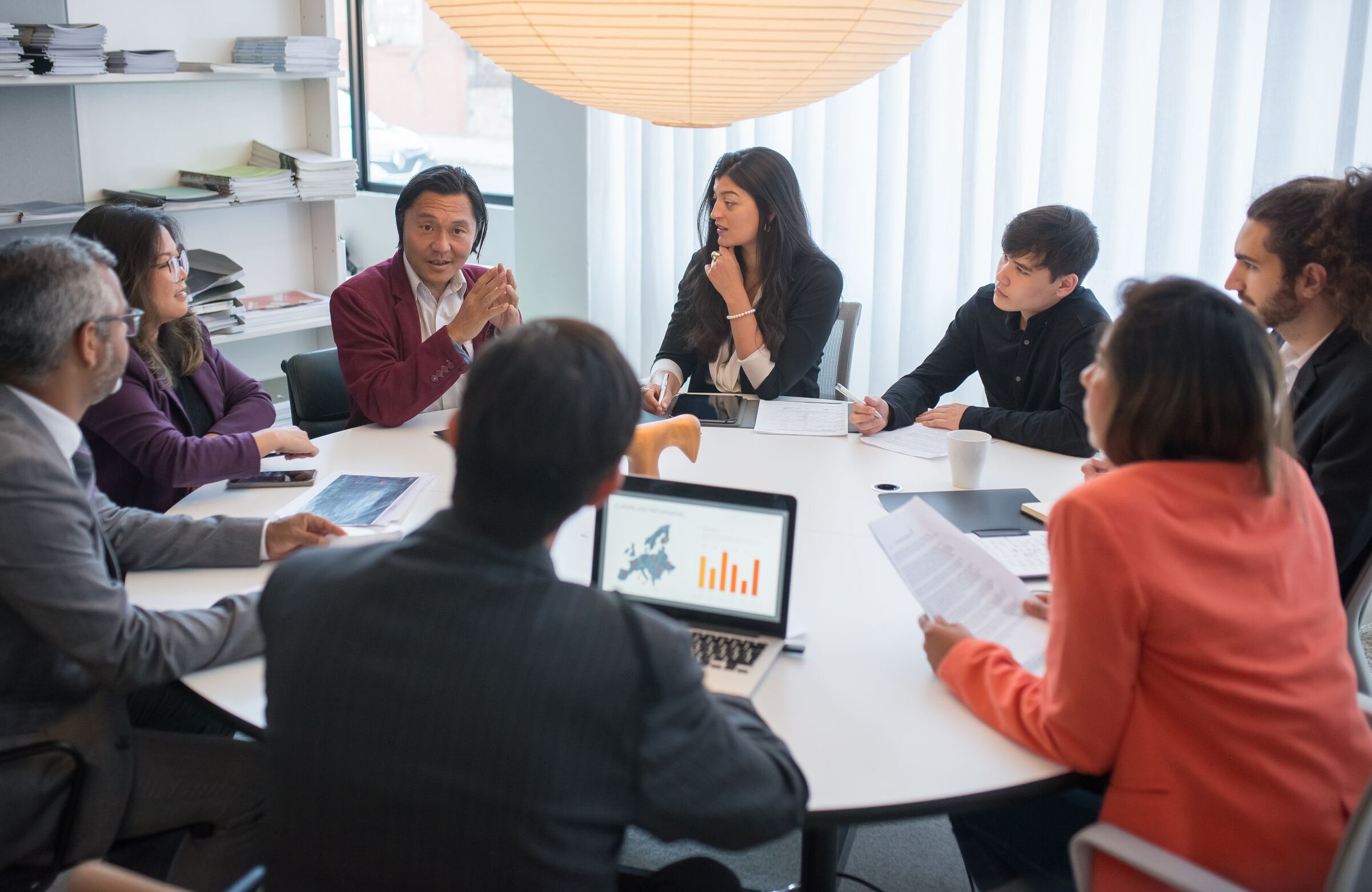 A diverse group of professionals collaborating in a modern conference room.